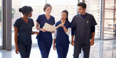 a group of nurses talking in the hallway